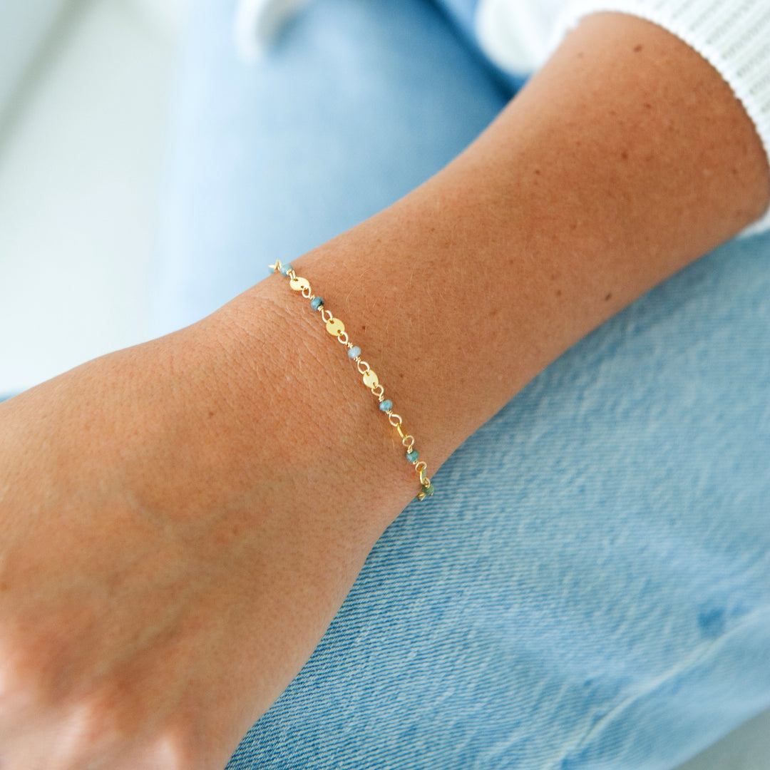 gold filled stardust bracelet in sterling silver or 14k gold filled with blue tourmaline on wrist