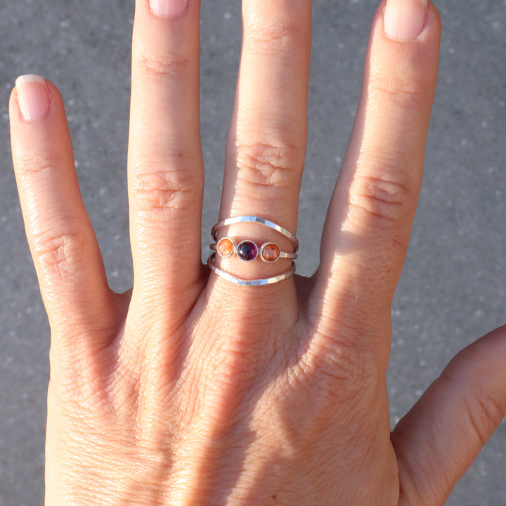 sterling silver one of a kind ring with sunstone and garnet gemstones on a hammered triple band