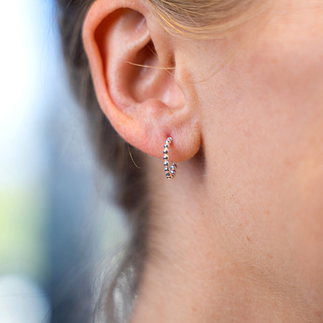 Ear hugger hoop earrings in smooth, hammered or beaded texture and sterling silver or 14k gold filled by Blossom and Shine