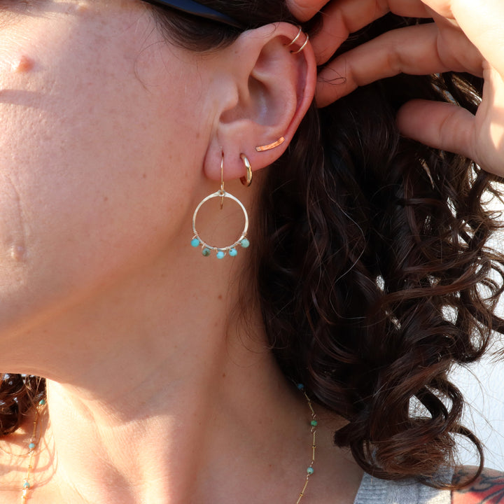 birthstone hoop earrings on model in 14k gold filled and december gemstone turquoise