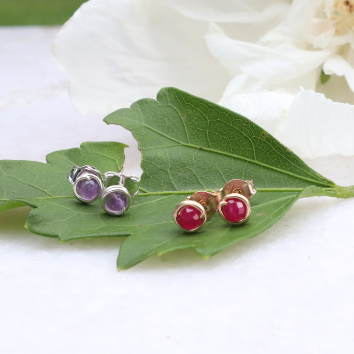 birthstone stud earrings with faceted amethyst and ruby gemstones in sterling silver and 14k gold filled