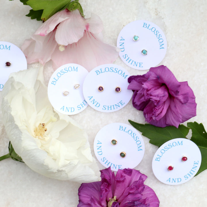 birthstone stud earrings with faceted gemstones on blossom and shine cards