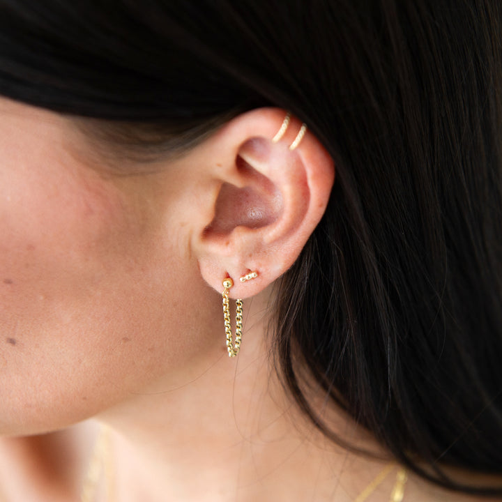 gold filled beaded stud earrings paired with aurora chain studs and ear cuff