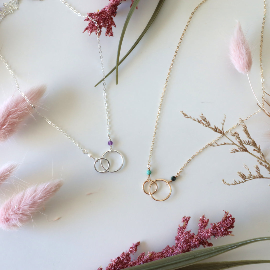 two personalized double circle linked necklaces in sterling silver and 14k gold filled with birthstone gemstones