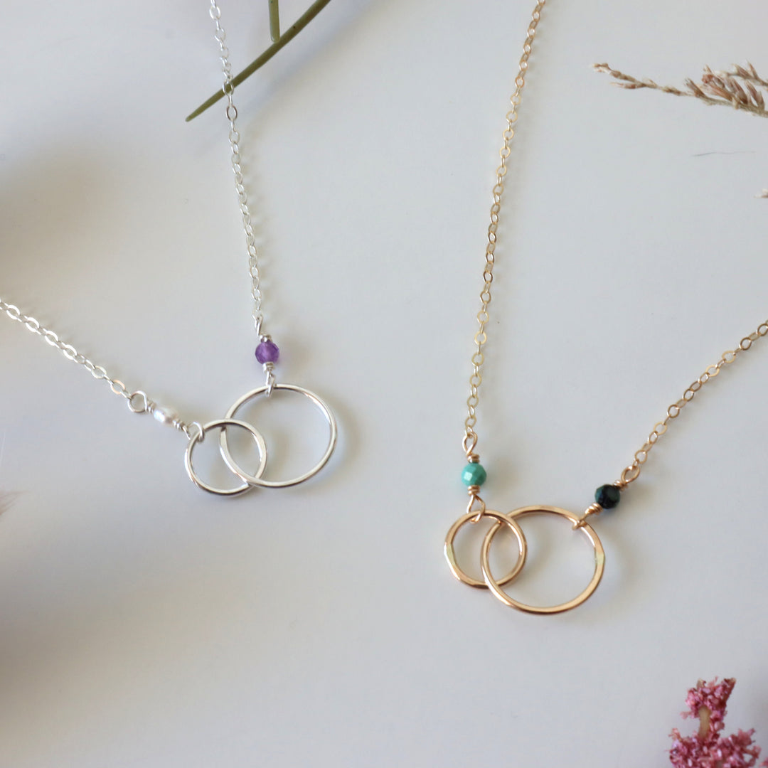 two personalized double circle linked necklaces in sterling silver and 14k gold filled with birthstone gemstones