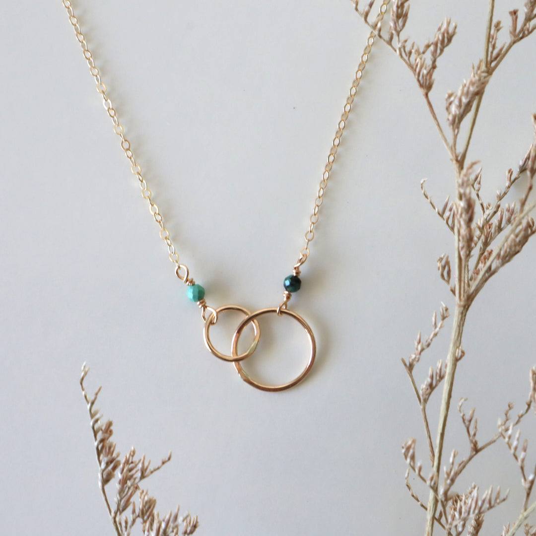 double linked circle necklace in 14k gold filled with turquoise and emerald gemstones