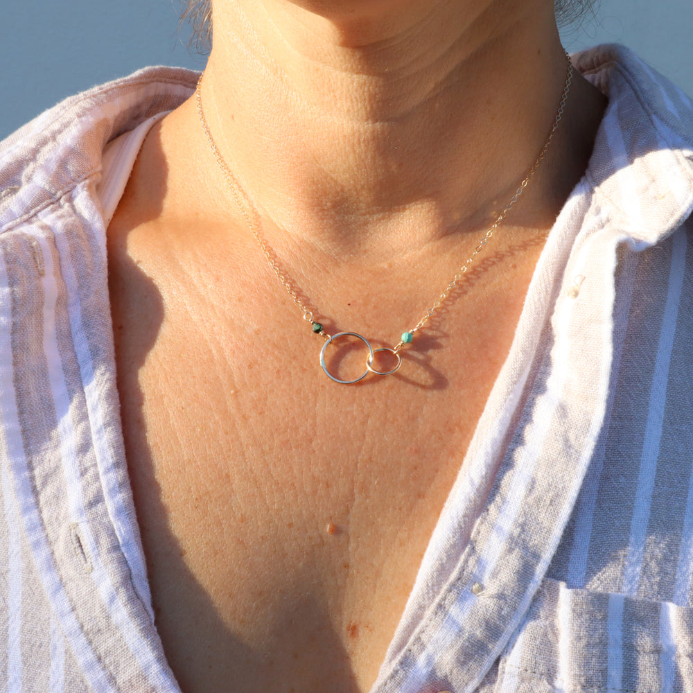 personalized double linked circle necklace in 14k gold filled with turquoise and emerald gemstones
