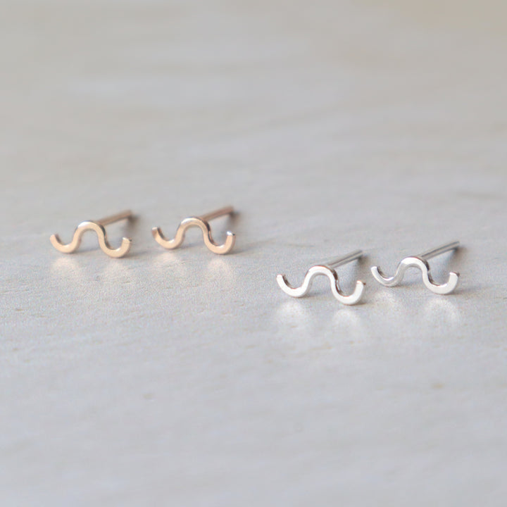 Pair of wavy line earrings on a light gray background