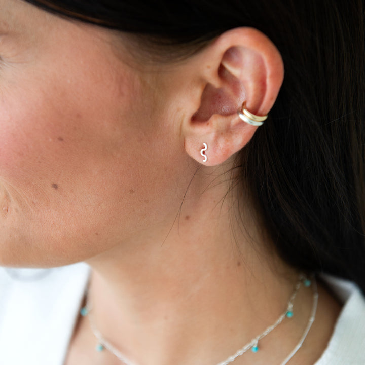 sterling silver squiggle stud earrings paired with classic ear cuffs