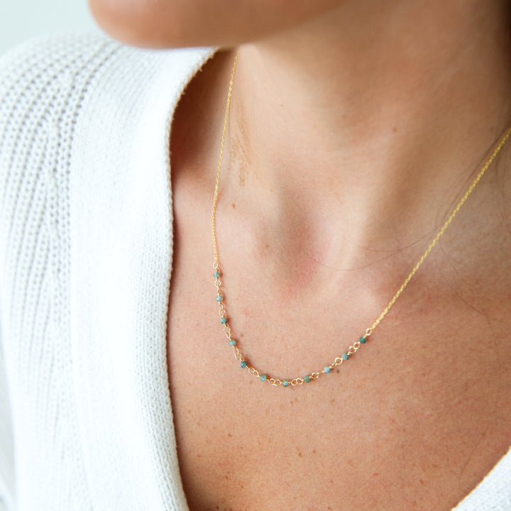 stardust necklace in 14k gold filled with  blue tourmaline on model