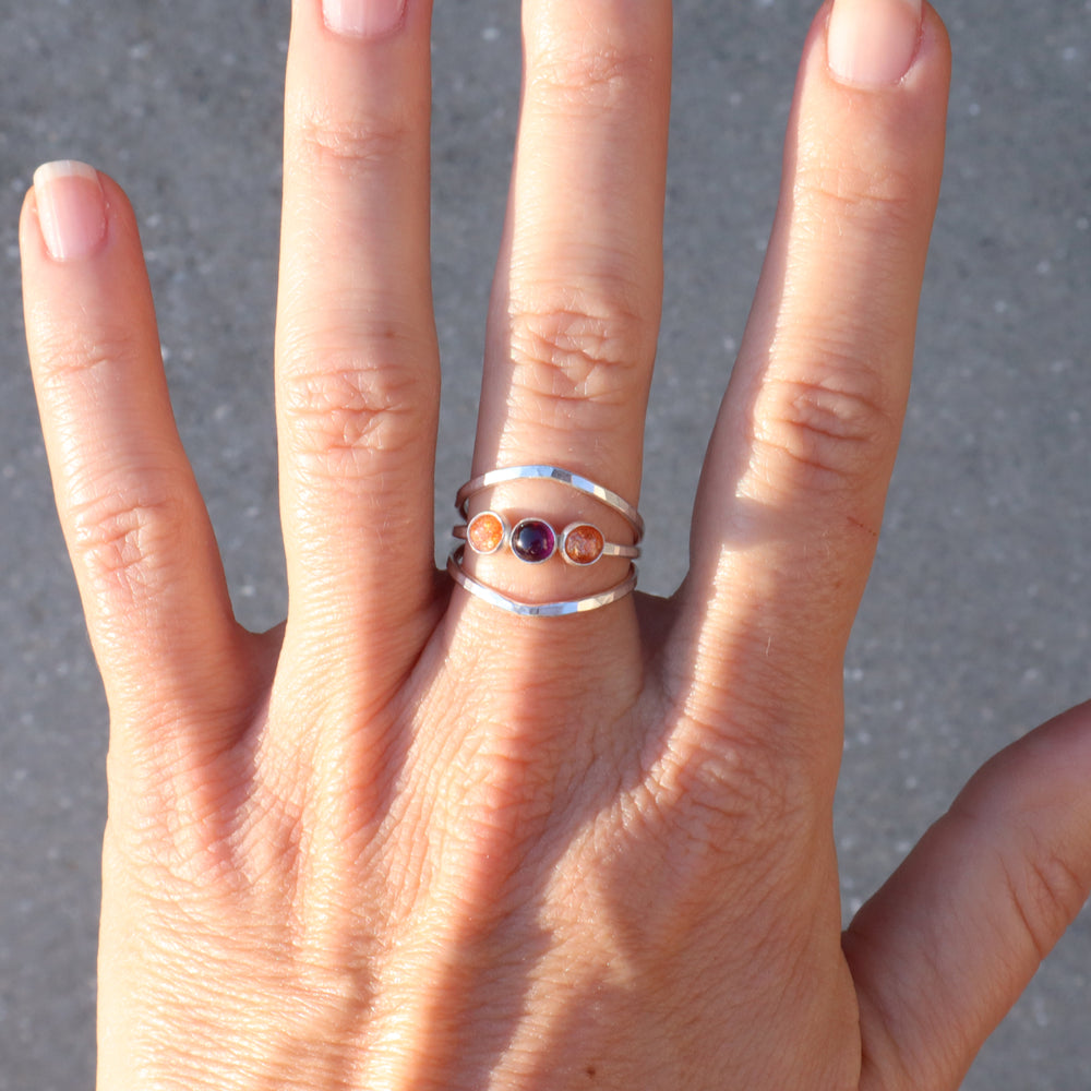 sterling silver one of a kind ring with sunstone and garnet gemstones on a hammered triple band